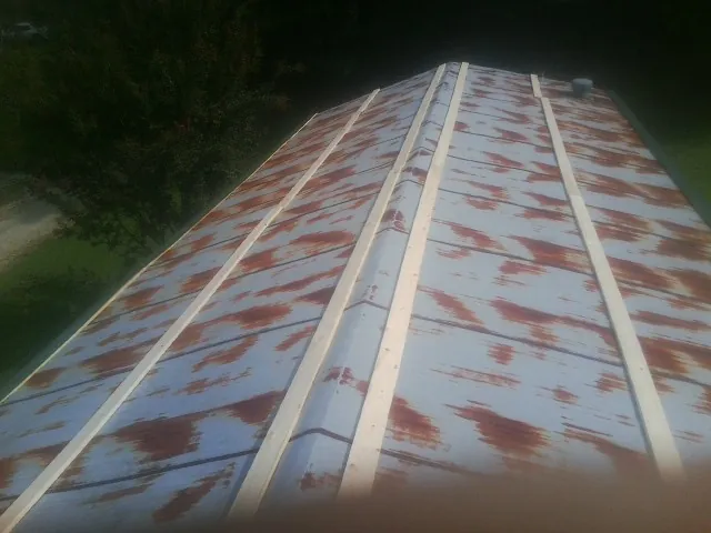 Rusted metal roof panels with new wood purlins before replacement — Storm Damage Roof Repair in Morgantown by Roofing Brothers